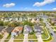 Wide aerial view of residential neighborhood with well-maintained houses, green spaces, and a scenic lake at 14110 Sapphire Bay Cir, Orlando, FL 32828