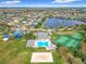 Aerial view showcasing community amenities like a pool, playground, tennis, and volleyball courts with greenery at 14110 Sapphire Bay Cir, Orlando, FL 32828