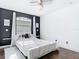 Stylized bedroom featuring dark accent wall, minimalist decor, and natural light from a window at 14110 Sapphire Bay Cir, Orlando, FL 32828