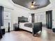 Elegant bedroom features a black ceiling fan, tray ceiling, and dark wood floors at 14110 Sapphire Bay Cir, Orlando, FL 32828