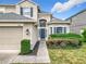 Close up front of home showing the two car garage and landscaping around the front door entrance at 14110 Sapphire Bay Cir, Orlando, FL 32828