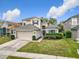 Charming two-story home with well-manicured lawn, mature landscaping, and attached two-car garage at 14110 Sapphire Bay Cir, Orlando, FL 32828