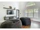 Bright living room with a large window, high ceiling, television, and sleek furniture arrangement at 14110 Sapphire Bay Cir, Orlando, FL 32828