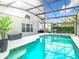 Lush screened pool and spa with string lights, perfect for outdoor entertaining and relaxation at 14110 Sapphire Bay Cir, Orlando, FL 32828