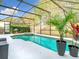 Relaxing screened pool and spa with lush landscaping and shaded seating, perfect for summer days at 14110 Sapphire Bay Cir, Orlando, FL 32828