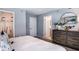 This spacious main bedroom has a large dresser, closet and minimalist modern decor at 2557 Penguin Blvd, Davenport, FL 33837