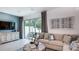 Inviting living room featuring a neutral color palette, contemporary furnishings, and sliding door to patio at 2561 Penguin Blvd, Davenport, FL 33837