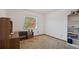 An empty bedroom featuring neutral carpet, a large window, and built-in shelving at 4089 Lehman Ln, Lakeland, FL 33813