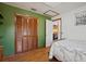 Bedroom featuring a wood floor, closet, and an open doorway to the living room at 4089 Lehman Ln, Lakeland, FL 33813