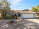 Charming single-story home with a well-manicured front yard, a two car garage, and brick driveway at 4089 Lehman Ln, Lakeland, FL 33813