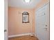 Entryway with wood floors, coat rack and adjacent door at 4089 Lehman Ln, Lakeland, FL 33813