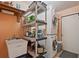 Inside laundry room with stacked washer and dryer, storage shelves, and laundry sink at 4089 Lehman Ln, Lakeland, FL 33813