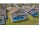 Aerial view of backyard with pool in screened enclosure and view of surrounding neighborhood at 540 Buckingham Cir, Davenport, FL 33897