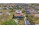 Aerial view of community pool and clubhouse with manicured landscaping and surrounding homes in a neighborhood at 540 Buckingham Cir, Davenport, FL 33897