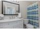 Bright bathroom with a large mirror, vanity and tub with a shower at 540 Buckingham Cir, Davenport, FL 33897