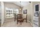 Cozy dining area with glass table and natural light from large window at 540 Buckingham Cir, Davenport, FL 33897