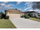 Well-kept home featuring a two-car garage, tidy front lawn, and convenient driveway at 540 Buckingham Cir, Davenport, FL 33897