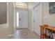 Bright foyer featuring tile flooring, decorative mosaic, and a glass-paneled front door for natural light at 540 Buckingham Cir, Davenport, FL 33897