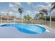 Relaxing screened-in pool area with clear blue water, white deck and comfortable chairs at 540 Buckingham Cir, Davenport, FL 33897