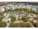 Aerial view of a large pool area with a lazy river, surrounded by palm trees and blue lounge chairs at 1529 Euston Dr, Reunion, FL 34747