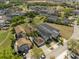 Aerial view of a residential area with houses, green spaces, a playground, and mature trees at 1529 Euston Dr, Reunion, FL 34747