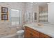 Charming bathroom with a wooden vanity, sailboat wallpaper, and natural light from the window at 1529 Euston Dr, Reunion, FL 34747