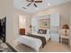 Bedroom featuring neutral paint and carpet, built-in shelving and an en-suite bathroom at 1529 Euston Dr, Reunion, FL 34747