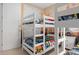 This charming bedroom features white bunk beds and custom Star Wars themed artwork at 1529 Euston Dr, Reunion, FL 34747