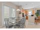 Dining room featuring a glass dining table set, a decorative light fixture and tile floors at 1529 Euston Dr, Reunion, FL 34747