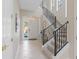 Bright foyer with a staircase and decorative tile flooring provides an inviting entryway at 1529 Euston Dr, Reunion, FL 34747