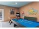 Fun game room with a pool table, foosball, and classic arcade games, ideal for Gathering entertainment at 1529 Euston Dr, Reunion, FL 34747