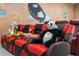 Comfortable tiered seating in the media room with stuffed animals and custom murals at 1529 Euston Dr, Reunion, FL 34747