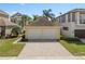 Detached two-car garage with brick driveway and well-maintained landscaping in a residential neighborhood at 1529 Euston Dr, Reunion, FL 34747