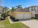 Detached two-car garage with lush landscaping, providing ample parking and curb appeal at 1529 Euston Dr, Reunion, FL 34747