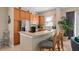 Kitchen area with stainless steel appliances, breakfast bar, and tile backsplash at 1529 Euston Dr, Reunion, FL 34747