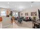 Bright living room featuring modern furniture, recessed lights, and open access to the kitchen at 1529 Euston Dr, Reunion, FL 34747