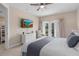 Spacious bedroom features a TV, ceiling fan and access to the private balcony at 1529 Euston Dr, Reunion, FL 34747