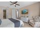 This spacious main bedroom features a TV, ceiling fan and balcony access at 1529 Euston Dr, Reunion, FL 34747