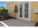 Outdoor patio with tiled flooring, an umbrella, and French doors leading indoors at 1529 Euston Dr, Reunion, FL 34747