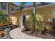 Charming walkway leading to the pool house with lush landscaping and a private backyard retreat at 1529 Euston Dr, Reunion, FL 34747