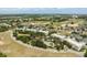 Wide aerial view showcasing the condominium buildings, community pool and tennis and pickleball courts at 7636 Heritage Crossing Way, Reunion, FL 34747