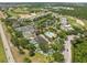 An aerial view of the community showcases tennis courts, a pool, a playground, and lush landscaping at 7636 Heritage Crossing Way, Reunion, FL 34747