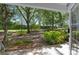 A tranquil backyard, lush greenery, brick-paved areas, and a variety of trees at 7636 Heritage Crossing Way, Reunion, FL 34747