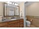 Neutral-toned bathroom featuring a spacious vanity with granite countertop and storage at 7636 Heritage Crossing Way, Reunion, FL 34747