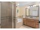 Bathroom featuring a walk-in shower, separate soaking tub, and granite countertop vanity at 7636 Heritage Crossing Way, Reunion, FL 34747