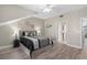 Comfortable bedroom with a luxurious bed, stylish side tables, and wood-look flooring at 7636 Heritage Crossing Way, Reunion, FL 34747