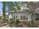 Back exterior of the property featuring a covered patio and lush landscaping at 7636 Heritage Crossing Way, Reunion, FL 34747