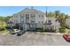 Three-story apartment building showcasing parking, landscaping, and architectural details at 7636 Heritage Crossing Way, Reunion, FL 34747