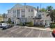 Exterior of a three-story building with ample parking and landscaped grounds at 7636 Heritage Crossing Way, Reunion, FL 34747