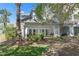 Back exterior of the property featuring a covered patio and lush landscaping at 7636 Heritage Crossing Way, Reunion, FL 34747